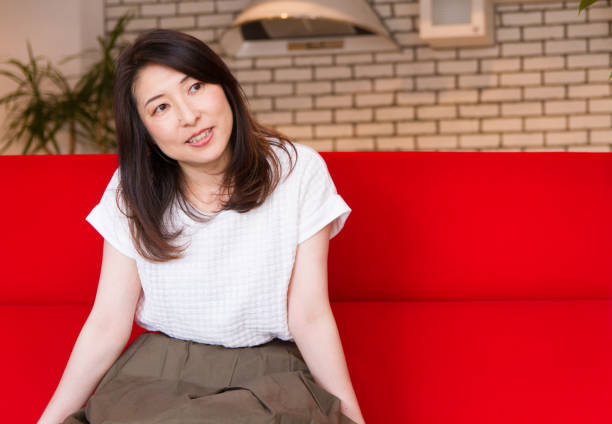 istock Japanese woman relaxing on the sofa 885332366