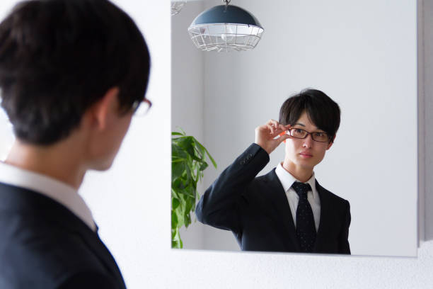 istock Japanese young business man fixing up at mirror 885332632