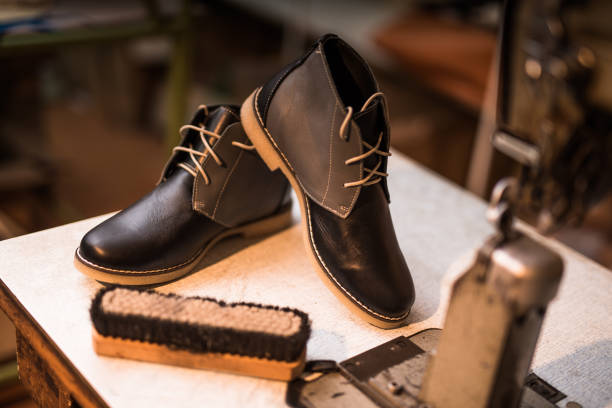 Beautiful custom made leather shoes next to sewing machine. Beautiful custom made leather shoes next to sewing machine. shoe polish photos stock pictures, royalty-free photos & images