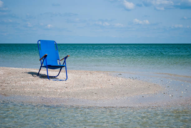 istock Blue beach chair on the beach blue sky white clouds summer 885333678