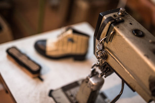 istock Old fashioned sewing machine and boots in the background. 885333740
