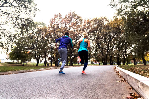 istock Jogging couple - young man and woman competing 885339610