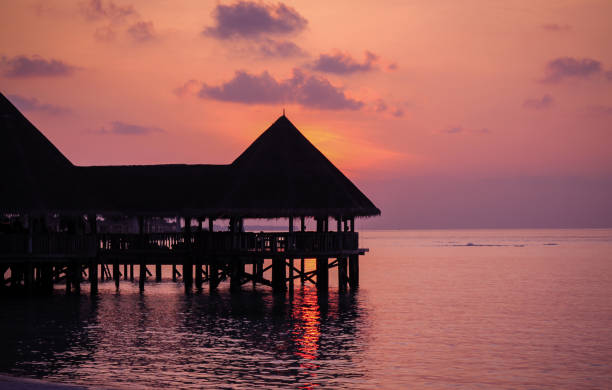 istock Over Water Bungalow in Sunset 885358158