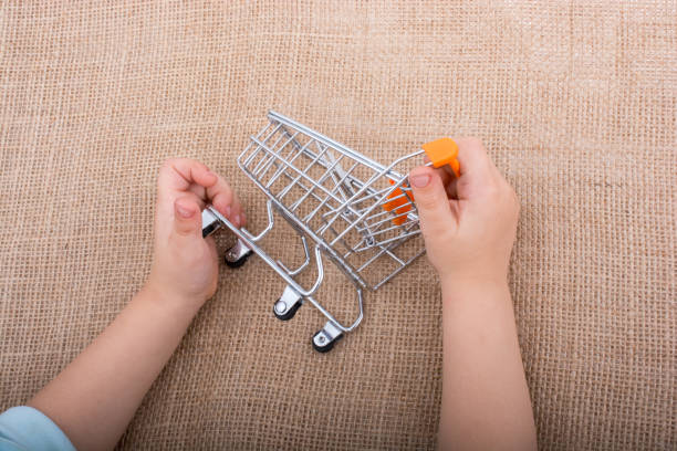 istock Shopping cart in  hand on canvas 885375148