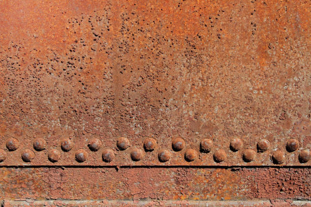 Rusty iron wall with rivets Rusty iron wall with rivets as background or texture ironclad stock pictures, royalty-free photos & images