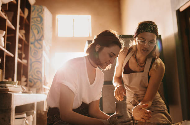 istock Woman teaching the art of pot making 885391112