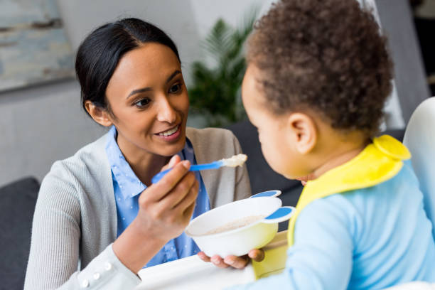 istock african american mother feeding baby 885394302