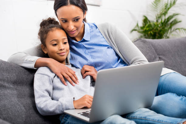 istock mother and daughter using laptop 885400784