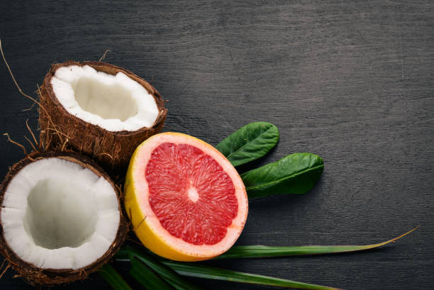 istock Coconut and grapefruit. Fresh fruits. On a wooden background. Top view. Free space for text. 885403254