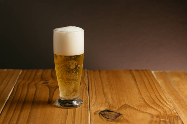 istock Glass of beer on wood table 885403722