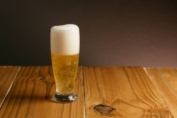 istock Glass of beer on wood table 885403724