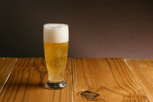 Glass of beer on wood table