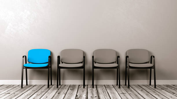 istock One Different Colored Chair in a Row of Grey 885411646