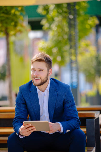 istock Young businessman on coffee break outdoors 885412380