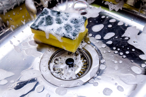 istock cleaning the sink in kitchen 885412412
