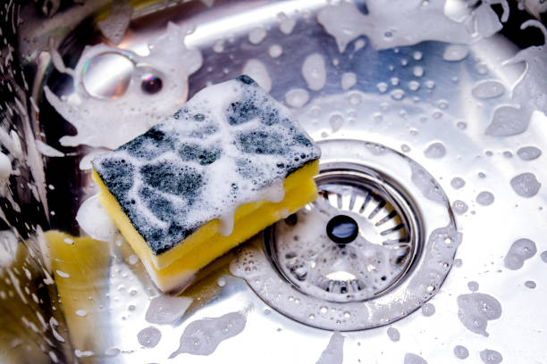 cleaning the sink in kitchen sponge in kitchen sink. Home cleaning concept. cleaning sponge photos stock pictures, royalty-free photos & images