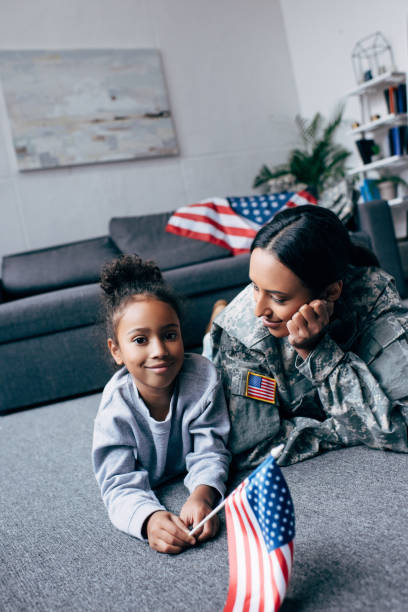 istock daughter and mother with american flag 885415038