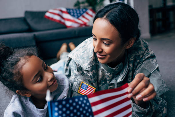 istock daughter and mother with american flag 885415252