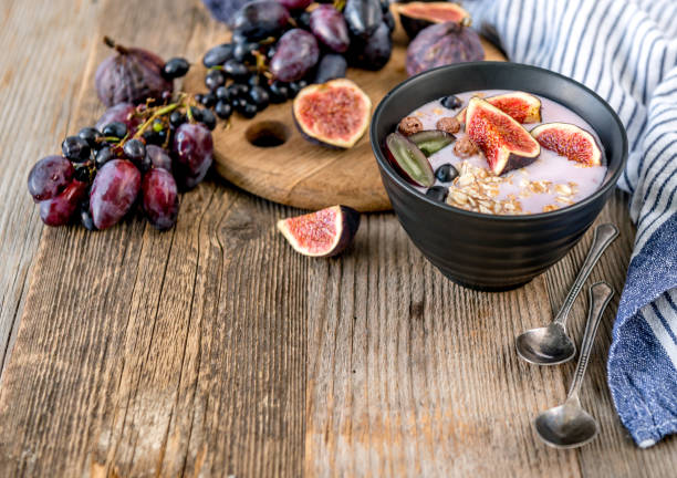 istock An useful dessert - yogurt, muesli and figs with grapes 885415512