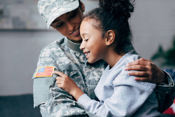 istock daughter hugging mother in military uniform 885418804