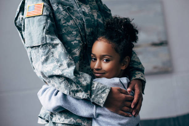 daughter hugging soldier cropped view of african american daughter hugging soldier in military uniform at home the black womens expo stock pictures, royalty-free photos & images