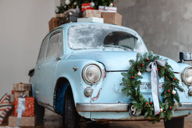 istock Blue retro car carrying giftboxes and xmas tree 885421342