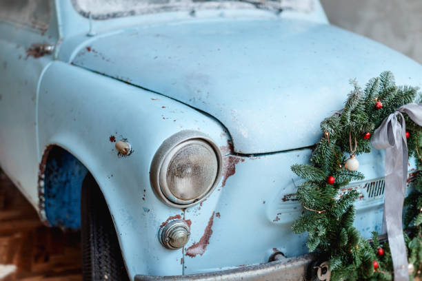 istock Blue retro car carrying giftboxes and xmas tree 885421414