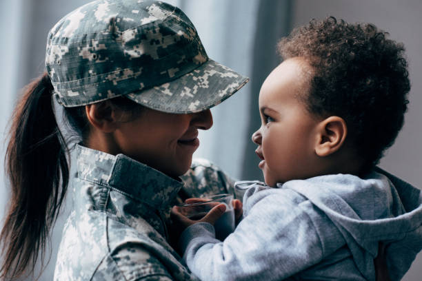 istock mother in military uniform with little son 885426932