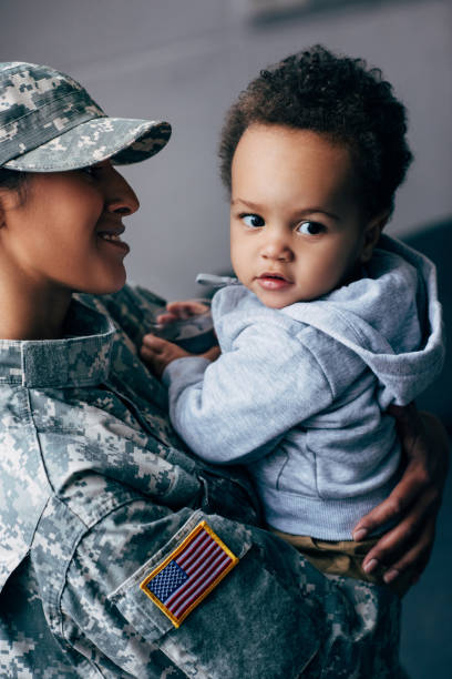 istock mother in military uniform with little son 885427018