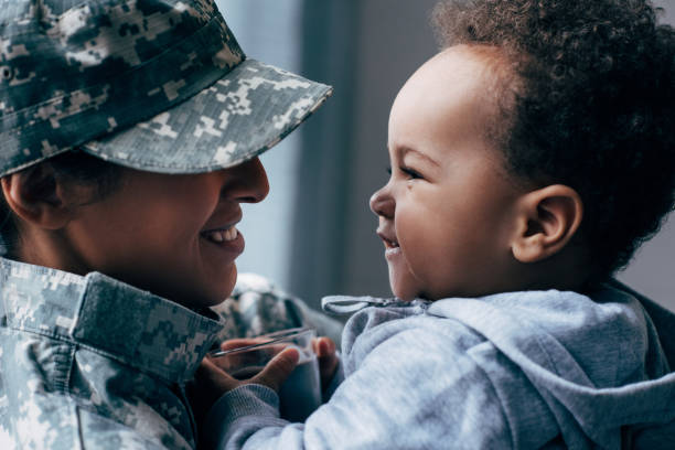 istock mother in military uniform with son 885429202