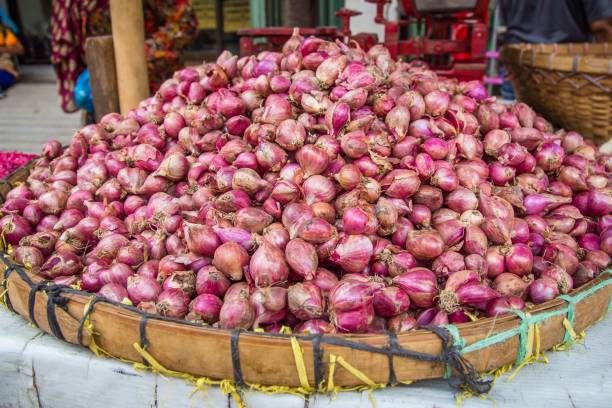 istock Onions in a basket on the market 885429388