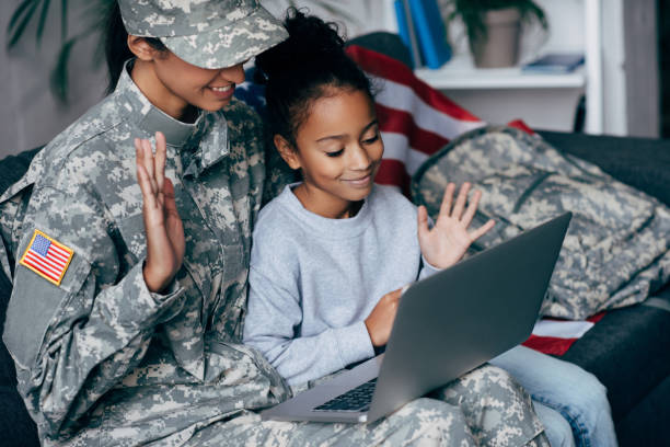 istock soldier and child making video call 885429666