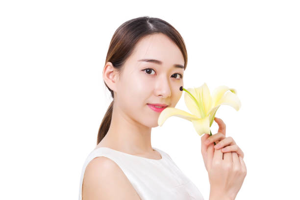 istock Beautiful woman holding yellow lily 885433088