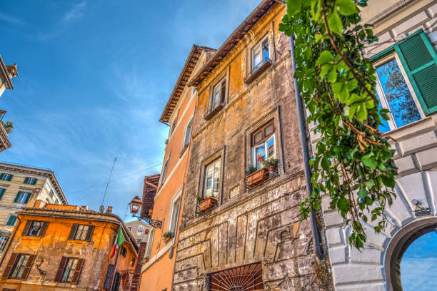 istock Old buildings in Rome under a blue sky 885438508