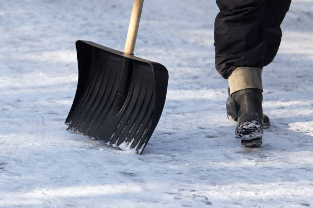istock Worker cleans snow shovel in the nature 885443386