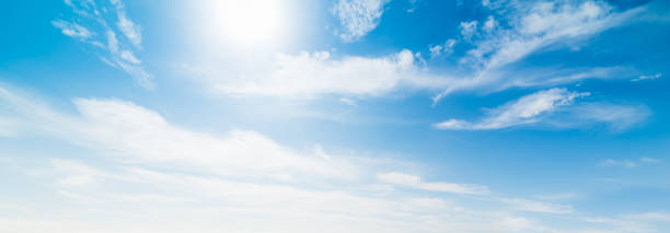 istock Sun shining amongs white clouds 885443726