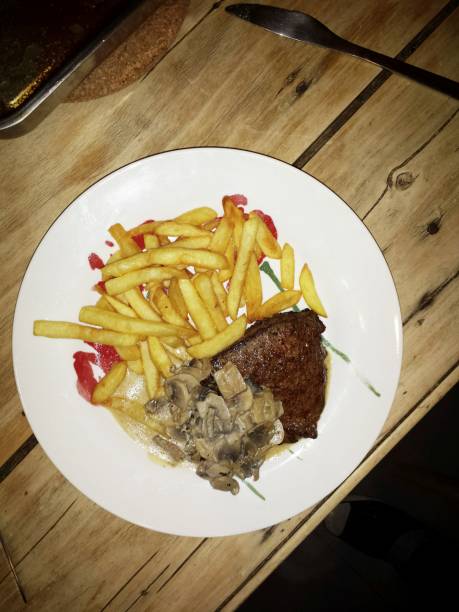 Steak with mushroom creme sauce and fried