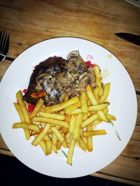 Steak with mushroom creme sauce and fried