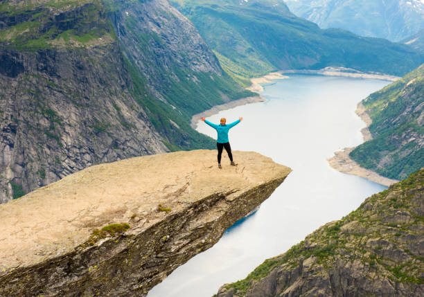 istock Sporty woman posing on Trolltunga Norway 885452054