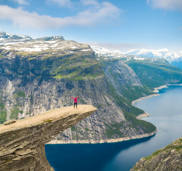 istock Sporty woman posing on Trolltunga Norway 885452116