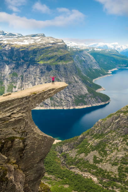 istock Sporty woman posing on Trolltunga Norway 885452216