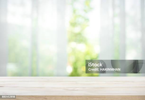 Wood Table On Blur Of Curtain With Window View Garden Stock Photo - Download Image Now