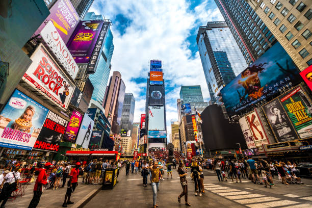 busy times square in nyc. the place is famous as world's busiest place for pedestrians and an iconic landmark for thousands of tourists in manhattan. - new york city times square crowd people imagens e fotografias de stock