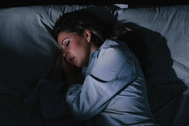 istock Woman peacefully sleeping in bed at night 885469560