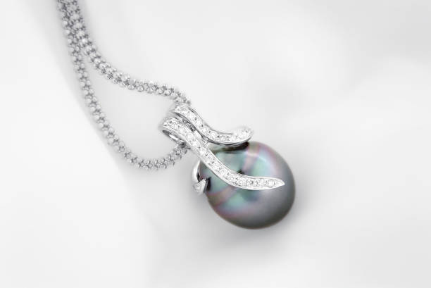 White gold pendant with tahitian pearl and diamonds White gold pendant with tahitian pearl and diamonds cultured cell stock pictures, royalty-free photos & images