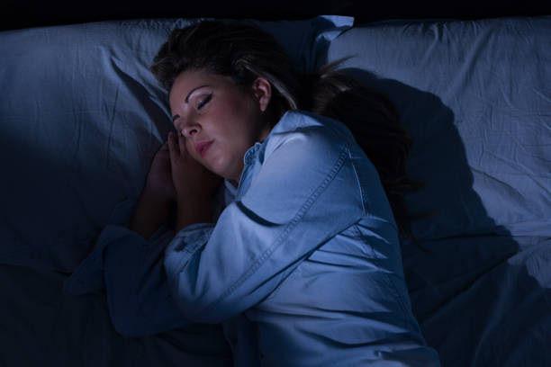 istock Woman peacefully sleeping in bed at night 885473958