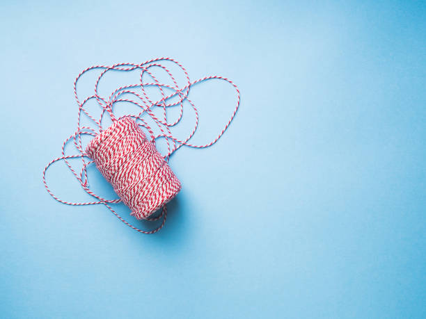 istock Red and white Twine on blue background 885476854