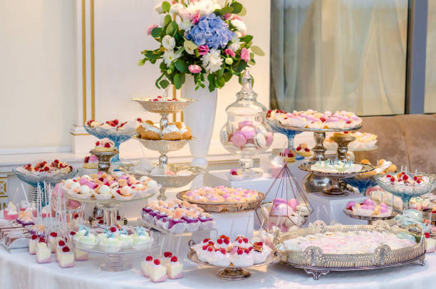 istock Delicious wedding reception candy bar dessert table full with panacota and edible silver. Luxury life. 885477698