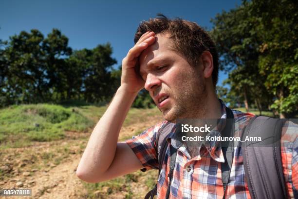 Tired Man In Forest Unfder Strong Sun With Backpack Travel In Asia Alone Suffer Form Sunstroke Stock Photo - Download Image Now