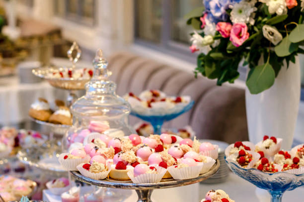 istock Delicious wedding reception candy bar dessert table full with panacota and edible silver. Luxury life. 885481092